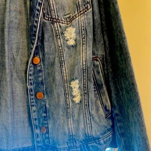 Distressed denim jacket for women in size medium.